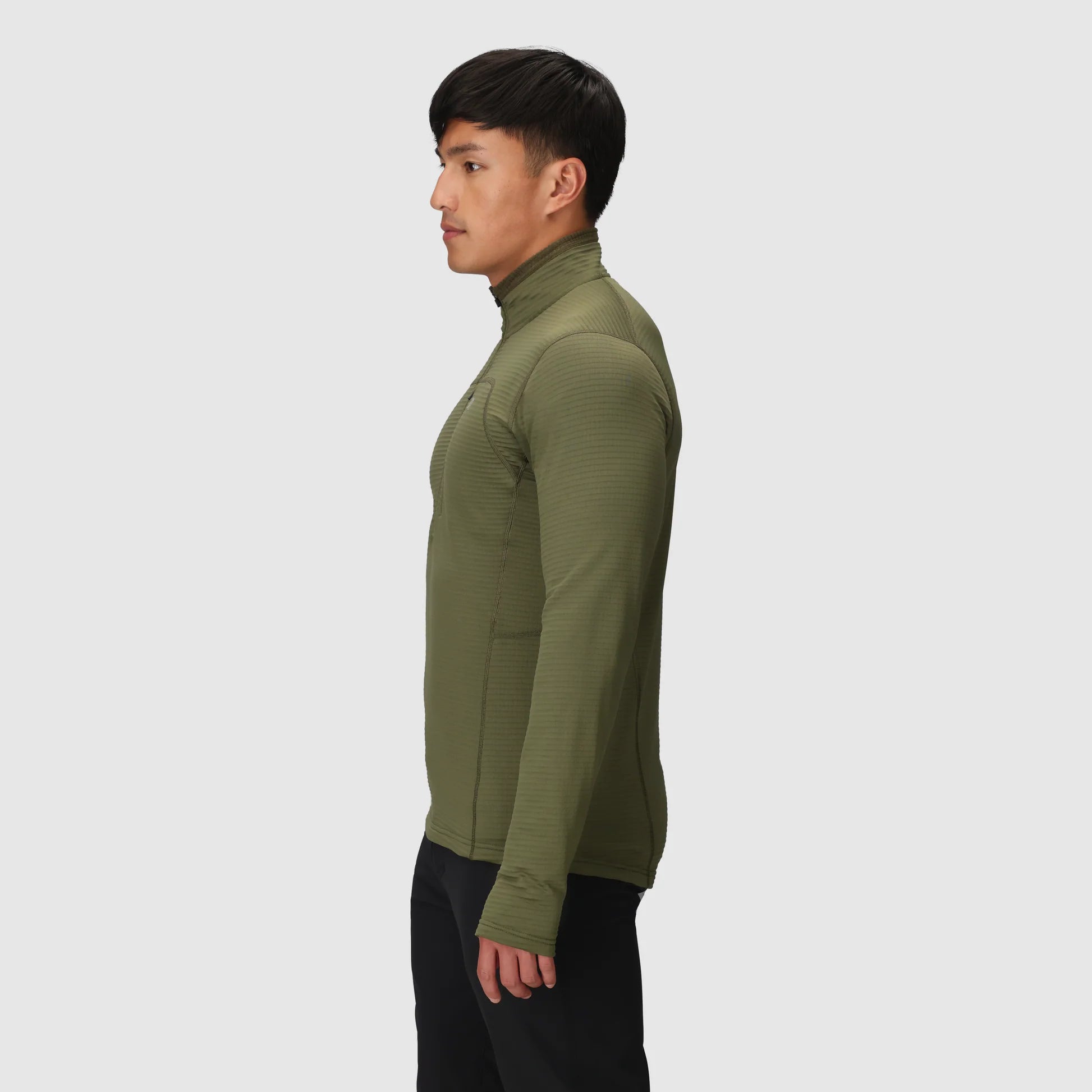 Person wearing a green turtleneck sweater on a white background