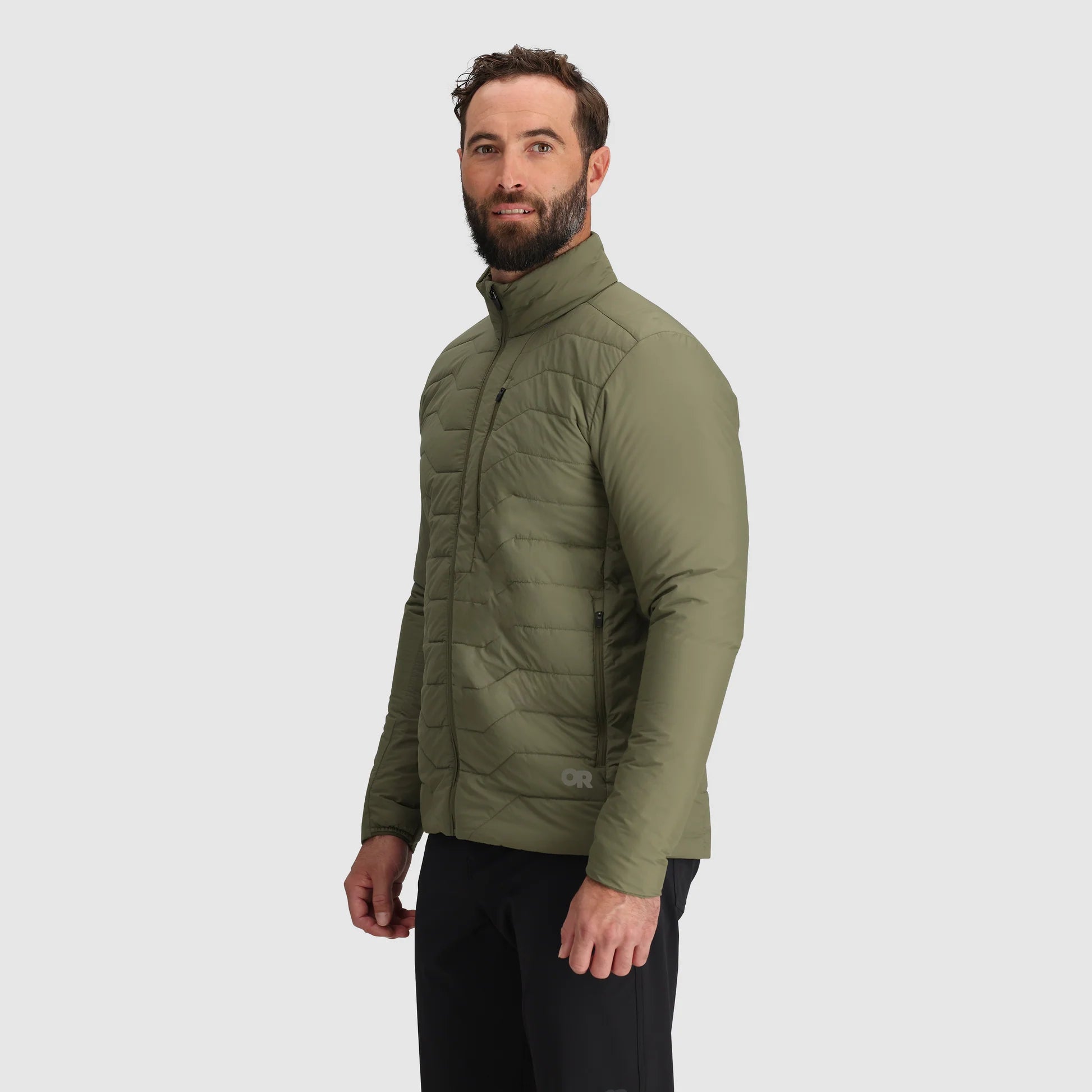 Man wearing a green puffer jacket on a white background