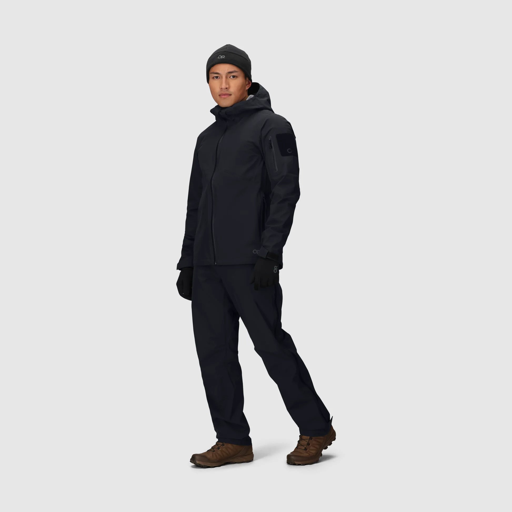 Person wearing a black tactical outfit on a white background