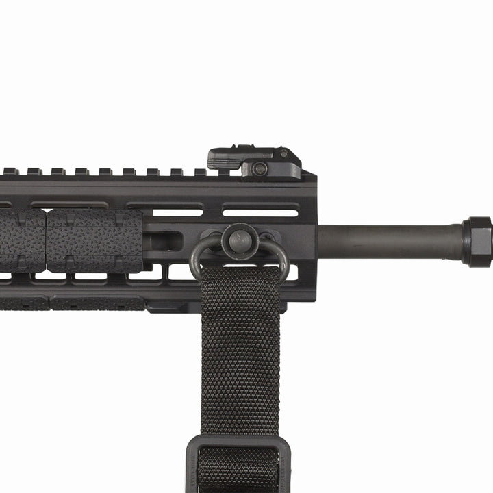 Close-up of a black rifle with a sling on a white background